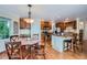 Charming kitchen boasts wood floors, island with seating, and ample cabinet space at 10472 Longleaf Dr, Parker, CO 80134