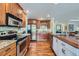 Well-equipped kitchen with stainless steel appliances, granite counters, and wood flooring at 10472 Longleaf Dr, Parker, CO 80134