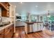 Open kitchen with island and stainless steel dishwasher flowing into adjacent living room at 10472 Longleaf Dr, Parker, CO 80134