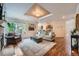 Inviting living room with a stone fireplace, large windows, and hardwood floors at 10472 Longleaf Dr, Parker, CO 80134