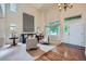 Inviting living room features soaring ceilings, a large window, and a cozy seating arrangement at 10472 Longleaf Dr, Parker, CO 80134