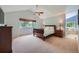 Spacious main bedroom with vaulted ceiling, large windows, and ensuite bathroom at 10472 Longleaf Dr, Parker, CO 80134