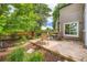 Home's back patio with mature landscaping, a wood fence, and outdoor seating at 10472 Longleaf Dr, Parker, CO 80134
