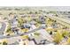 Aerial view of the neighborhood featuring various house styles, roads, and green spaces on a sunny day at 9060 Ferncrest St, Firestone, CO 80504