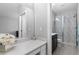 Contemporary bathroom with white countertops, black cabinets, and a glass-enclosed shower at 9060 Ferncrest St, Firestone, CO 80504