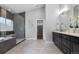 Elegant bathroom featuring a glass shower, soaking tub, and double vanity with modern fixtures at 9060 Ferncrest St, Firestone, CO 80504