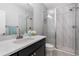 Modern bathroom featuring a sleek shower, decorative tile, and black vanity at 9060 Ferncrest St, Firestone, CO 80504