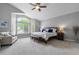 Inviting bedroom with large windows, a sitting area, and a king-size bed with plush bedding at 9060 Ferncrest St, Firestone, CO 80504