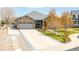 Charming single-story home with a stone facade, three-car garage and well-manicured lawn at 9060 Ferncrest St, Firestone, CO 80504