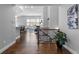 Inviting foyer with hardwood floors, staircase, and views into the living room with ample natural light at 9060 Ferncrest St, Firestone, CO 80504