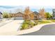 Charming single-story home with stone facade, mature landscaping, and a spacious two-car garage at 9060 Ferncrest St, Firestone, CO 80504