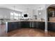 Well-appointed kitchen with dark cabinetry, stainless steel appliances, and modern countertops at 9060 Ferncrest St, Firestone, CO 80504