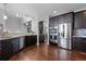 Spacious kitchen featuring stainless steel appliances and dark wood cabinets at 9060 Ferncrest St, Firestone, CO 80504