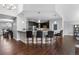 Bright open kitchen with stainless steel appliances, a large breakfast bar with pendant lighting at 9060 Ferncrest St, Firestone, CO 80504