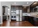 Gourmet kitchen with stainless steel appliances, ample cabinetry, and access to a dining area at 9060 Ferncrest St, Firestone, CO 80504