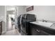 Well-equipped laundry room with modern washer and dryer, sink, and granite countertops at 9060 Ferncrest St, Firestone, CO 80504