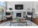 Comfortable living room featuring a fireplace with stone surround and built-in shelving at 9060 Ferncrest St, Firestone, CO 80504