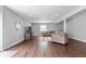 Spacious living room with hardwood floors, neutral walls, and a comfortable sectional sofa at 9060 Ferncrest St, Firestone, CO 80504