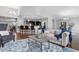 Open-concept living area with hardwood floors, breakfast bar, and plenty of seating at 9060 Ferncrest St, Firestone, CO 80504