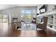 Spacious living room with vaulted ceilings, large windows, a fireplace, and hardwood floors at 9060 Ferncrest St, Firestone, CO 80504