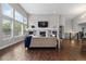 Bright living room with large windows, fireplace, and open floor plan at 9060 Ferncrest St, Firestone, CO 80504