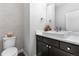 Chic powder room with a vessel sink, dark cabinets, and a decorative tile accent wall at 9060 Ferncrest St, Firestone, CO 80504