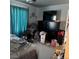 Bedroom features a bed, dresser, laminate flooring and blue window coverings at 15603 E 51St Pl, Denver, CO 80239