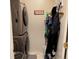 Laundry room area featuring stackable washer and dryer, storage and coat hooks at 15603 E 51St Pl, Denver, CO 80239