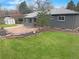 Spacious backyard with lawn, stone patio, well-maintained landscaping, and garden shed at 9639 W 63Rd Pl, Arvada, CO 80004
