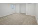 Finished basement area with neutral carpet, white walls, and a closet at 9639 W 63Rd Pl, Arvada, CO 80004
