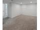 Finished basement area with neutral carpet, white walls, and two access doors at 9639 W 63Rd Pl, Arvada, CO 80004