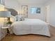 Bright bedroom features wood floors, neutral walls, and large windows, with a queen bed at 9639 W 63Rd Pl, Arvada, CO 80004