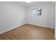 Clean bedroom features two windows, neutral walls, wood floors, and white trim at 9639 W 63Rd Pl, Arvada, CO 80004