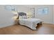 Bright bedroom features wood floors, neutral walls, and large windows, with a queen bed at 9639 W 63Rd Pl, Arvada, CO 80004