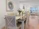 Stylish dining room with seating for six, open to the living area, bathed in natural light for inviting gatherings at 9639 W 63Rd Pl, Arvada, CO 80004
