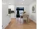 Elegant dining area with table for six, seamlessly connects to the living room and kitchen, perfect for modern living at 9639 W 63Rd Pl, Arvada, CO 80004