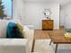 Cozy living room with wood floors, natural light, stylish furniture, and a decorative mirror, creating a welcoming atmosphere at 9639 W 63Rd Pl, Arvada, CO 80004