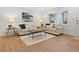 Bright living room features wood floors, a large window, and neutral furniture for a comfortable and inviting space at 9639 W 63Rd Pl, Arvada, CO 80004