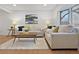 Bright living room features wood floors, a large window, and neutral furniture for a comfortable and inviting space at 9639 W 63Rd Pl, Arvada, CO 80004