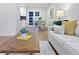 Open-concept living room with seamless transition to the kitchen and dining, complemented by wood floors and modern décor at 9639 W 63Rd Pl, Arvada, CO 80004