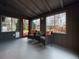 Cozy sunroom with dark gray walls and ceiling, and views of the landscaped backyard at 9639 W 63Rd Pl, Arvada, CO 80004
