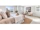 Bright bedroom with a large bed, neutral color palette, and windows offering exterior views at 821 Boulder Peak Ave, Erie, CO 80516