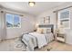 Comfortable bedroom with cozy rug, gray headboard, and natural lighting at 821 Boulder Peak Ave, Erie, CO 80516