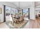 Bright dining room featuring a modern light fixture and view to the backyard through large sliding glass doors at 821 Boulder Peak Ave, Erie, CO 80516