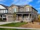 Charming two-story home featuring a covered porch, well-kept lawn, and inviting curb appeal at 821 Boulder Peak Ave, Erie, CO 80516