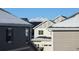 View of neighborhood homes with snowy rooftops and Longs Peak in the distance at 821 Boulder Peak Ave, Erie, CO 80516