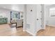 Open hallway leading to a living area, featuring wood floors and neutral wall colors at 821 Boulder Peak Ave, Erie, CO 80516