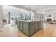 Kitchen island with decorative wood cabinets, stone countertop, stainless steel appliances, and adjacent eat-in dining at 821 Boulder Peak Ave, Erie, CO 80516