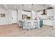Open eat-in kitchen with a large island, stainless steel appliances, pendant lighting and barstool seating at 821 Boulder Peak Ave, Erie, CO 80516