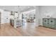 Eat-in kitchen features stainless steel appliances, a white quartz island with barstool seating, and an open floor plan at 821 Boulder Peak Ave, Erie, CO 80516